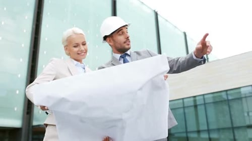 Architects Reviewing Blueprints at Construction Site