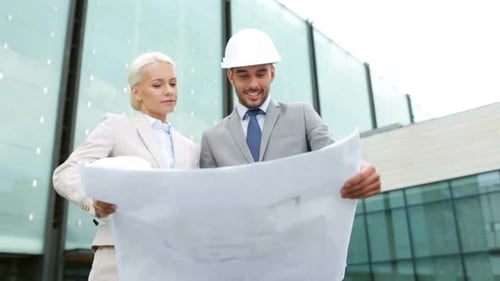 Architects and Engineers Review Blueprints Outside Building