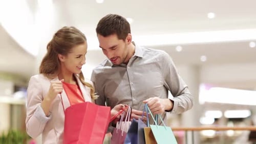 Happy Young Couple With Shopping Bags In Mall 3