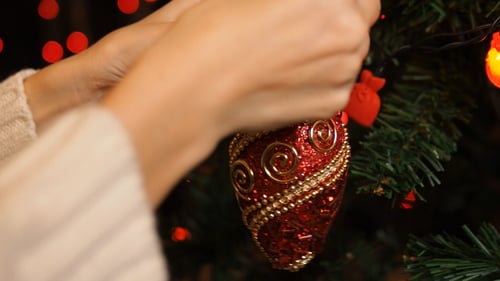 Christmas Ornament Hanging on Lit Christmas Tree