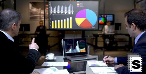 Businessmen Analyzing Charts and Graphs in Modern Office