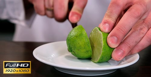 Close Up of a Lime Being Cut on Plate
