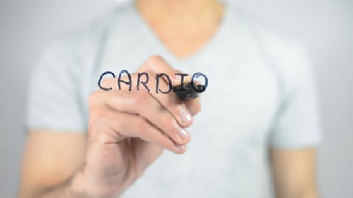 Person Writes Cardio on Clear Surface with Marker