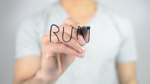 Hand Writes Run on Glass Surface Close Up