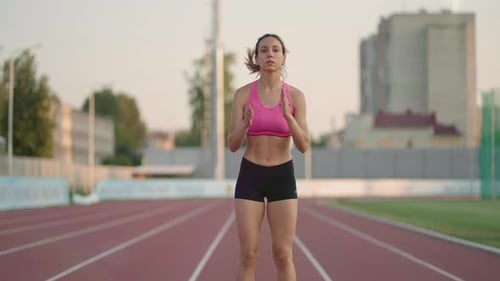 Woman Stretching Before Workout on Running Track