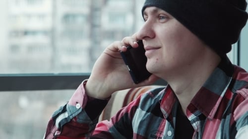 Man Speaks By Phone in Cafe