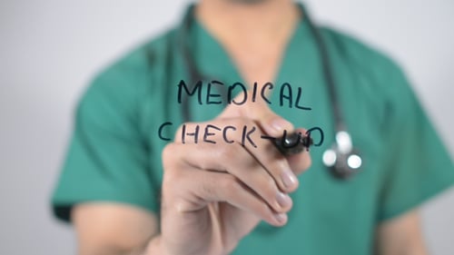 Doctor Writing Medical Check-Up with Black Pen