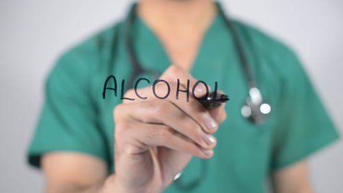 Medical Professional Writes "Alcohol" on Glass Surface