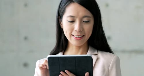 Young Woman Using Tablet in Office Building
