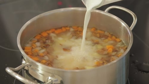 Creamy Vegetable Soup Cooking in a Silver Pot