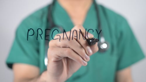 Doctor Writes Pregnancy on Transparent Surface