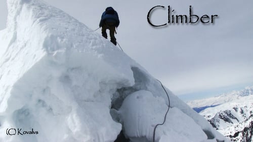Mountaineer Ascends Snowy Peak in Winter Landscape