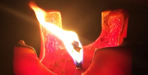 Burning Red Candle Flame in the Dark