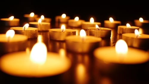 Glowing Tea Light Candles Flicker in the Darkness