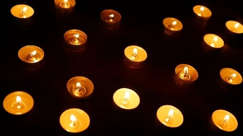 Golden Tea Candles Glowing in the Dark