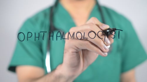 Ophthalmologist Writing on Clear Surface in Close Up