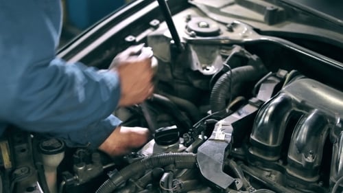 Auto Mechanic Working on Car Engine