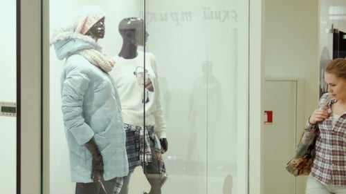 The Girl Looks At a Show-window Of Clothing Store
