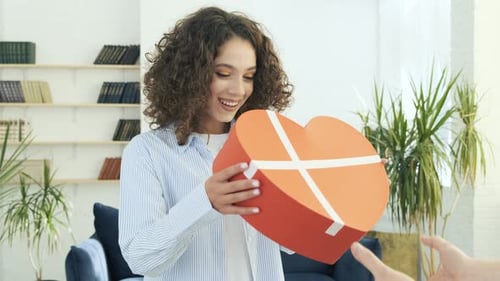 Happy Woman Receives Heart-Shaped Birthday Gift