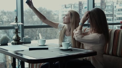 Two Girlfriends Do Selfie In Cafe