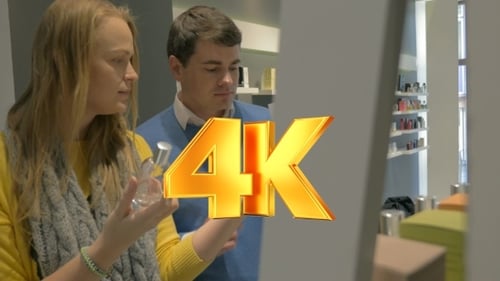 Man And Woman Trying Fragrances In Perfumery Shop