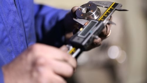 Worker Measuring Caliper