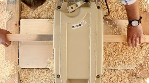 Man Using Woodworking Machine in Workshop Top Down