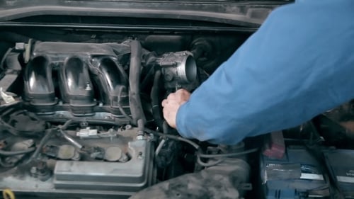 Mechanic Repairing Car Engine Under the Hood
