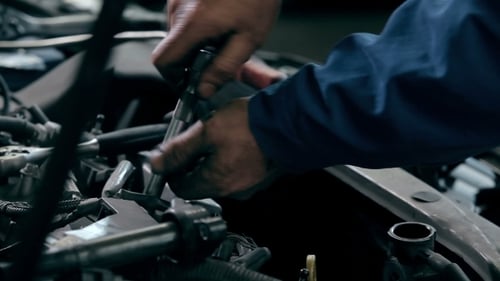 Mechanic Working on a Car Engine Close Up