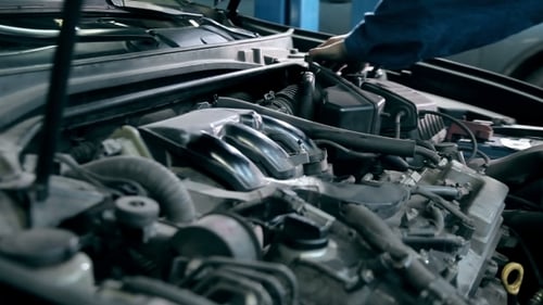 Mechanic Repairing Car Engine at Auto Repair Shop