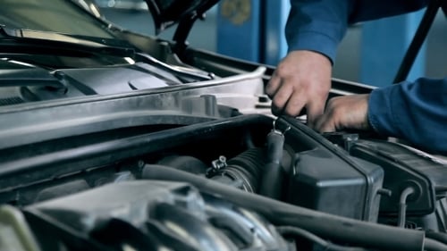 Mechanic Fixing a Problem With The Engine
