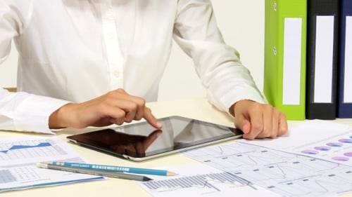 Business Woman Uses Tablet at Desk