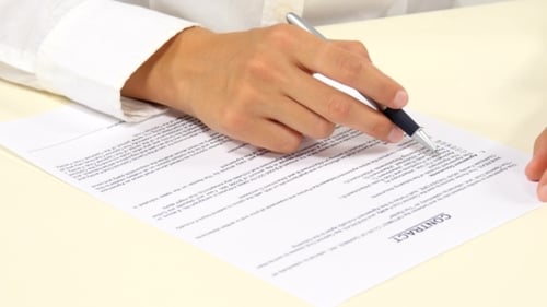 Young Adult Signs Business Contract Indoors