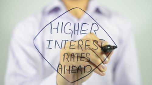 Hand Writes Higher Interest Rates Ahead