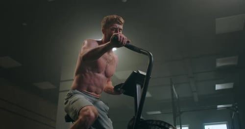 Fitness Man on Bicycle Doing Spinning at Gym, Fit Young Male Working Out on Gym Bike