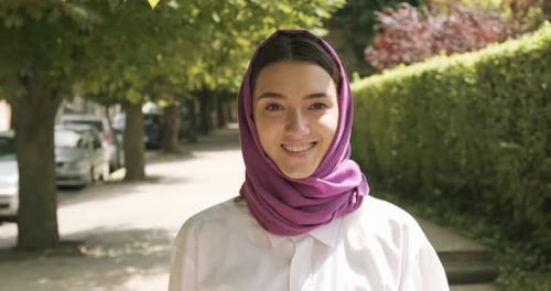 Beautiful Young Woman Walk at the Street, Wearing Traditional Headscarf. Attractive Female in Hijab