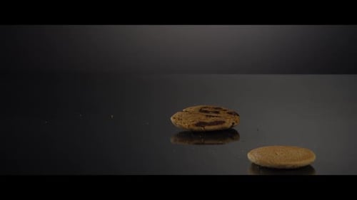 Falling cookies from above onto a reflective surface - COOKIES