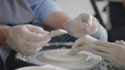 Hands Shaping Clay on Pottery Wheel
