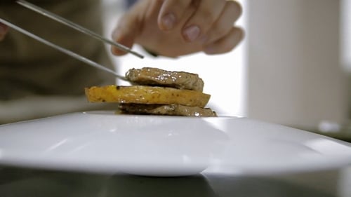 Chef Plating Gourmet Dish in a Restaurant Kitchen