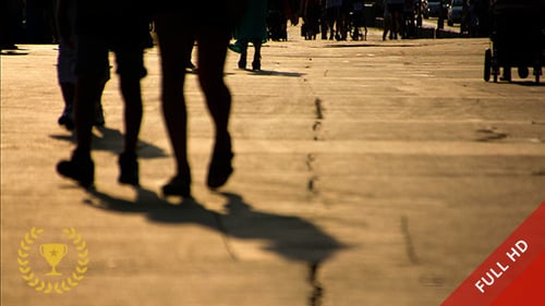 People Walking in the City at Sunset