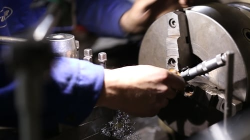 Lathe Shaping Metal by a Machine Operator