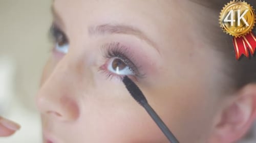 Stylist is Putting On Black Mascara