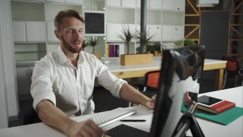 Happy Businessman In Office Working At Computer.