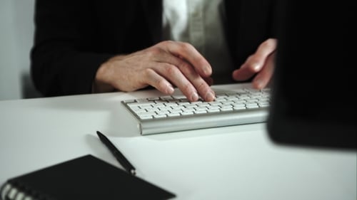 Man Typing at Computer in Office Workplace