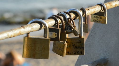 Love Locks Hanging on Railing by the Ocean