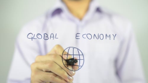 Writing Global Economy and Drawing Globe on Glass