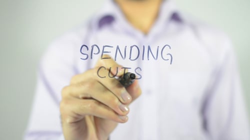 Spending Cuts Written on Clear Surface