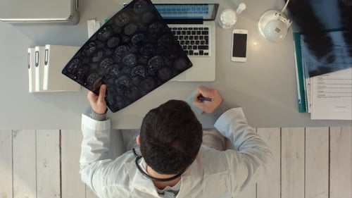 Top View Of Doctor Interpreting Scan Of The Brain