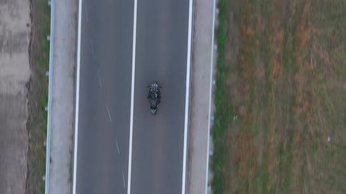 Top View to Motorcyclist Racing His Motorcycle on Country Road