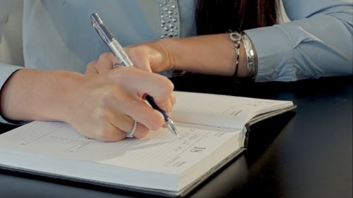 Female Hand Writing In Notebook